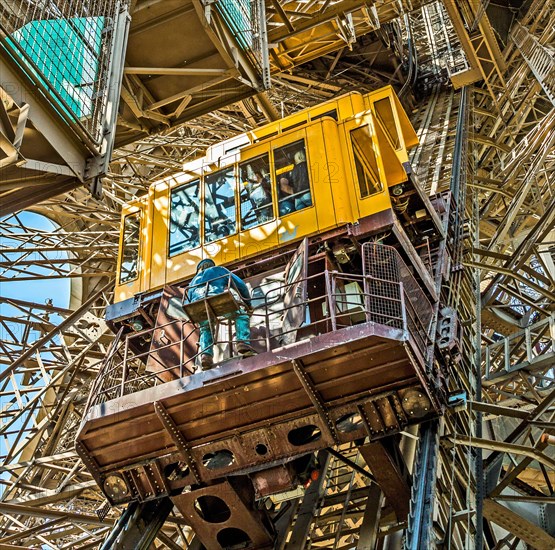 people in the lift at the southern tower of the Eiffel tower