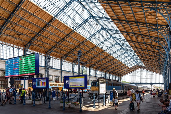 Commuters coming and going inside the Nyugati Railway Station in Budapest, Hungary