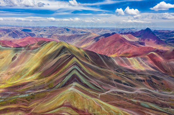 Aerial view of the entire Rainbow Mountains in Peru with Vinicunca in the center and the Red Valley in the background.