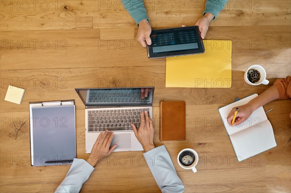 Business people working at a coworking space overhead view