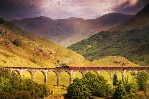 Jacobite steam train crossing Glenfinnan viaduct