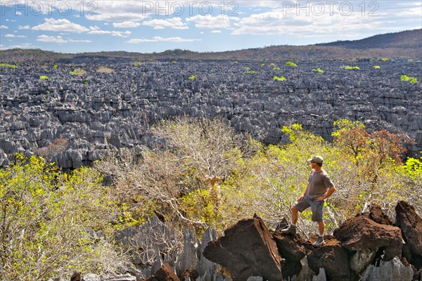 Tourist observing the Tsingy (limestone karsts) Rary of Ankarana National Park in northern Madagascar.