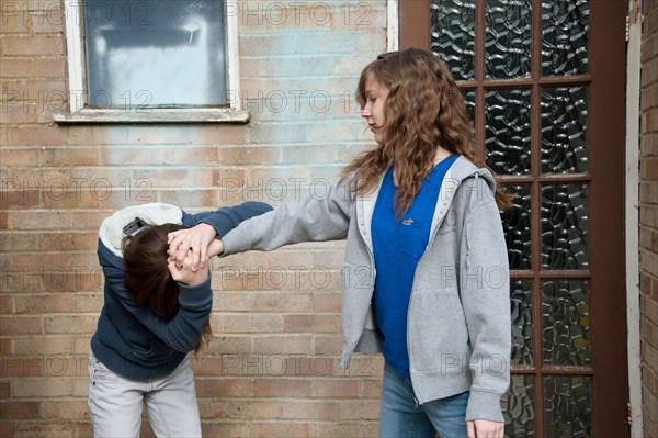 Older girl bullying a younger child