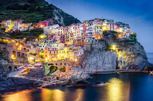 Scenic night view of colorful village Manarola in Cinque Terre, Italy