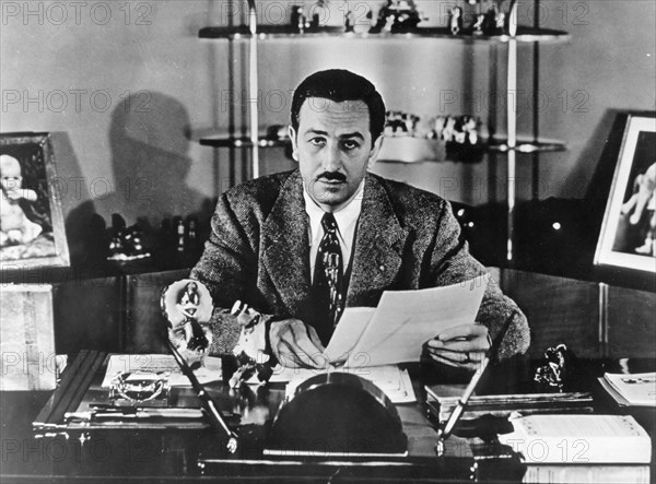 Walt Disney sitting in his office