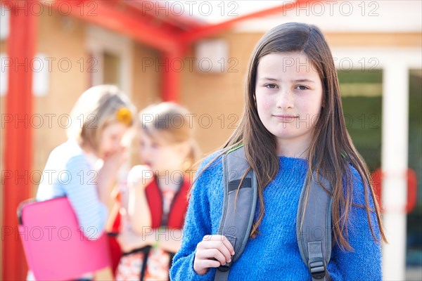 Unhappy Girl Being Gossiped About By School Friends
