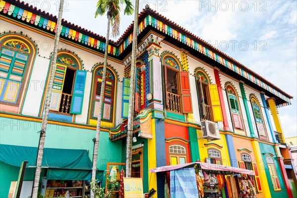 HDR rendering of a colorful building facade in Little India, Singapore, with tall high-rise apartments in the background.