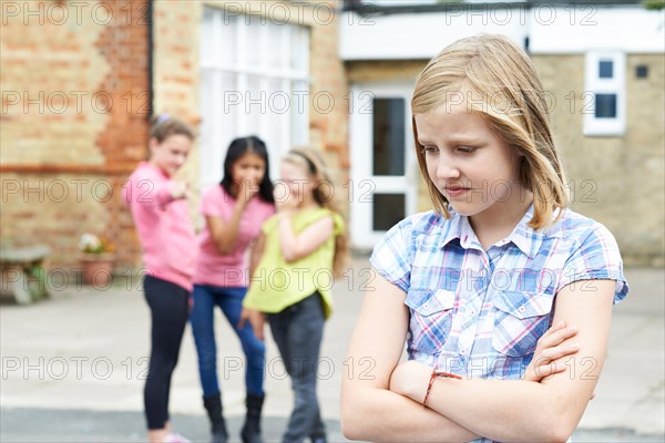 Unhappy Girl Being Gossiped About By School Friends