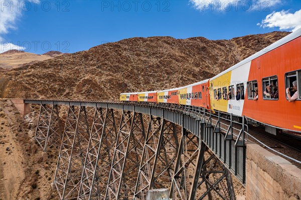 Train to the clouds (tren a las nubes) crossing La Polvorilla bridge in the Altiplano 4.200 meters/13800 feet high, Salta Province, Argentina