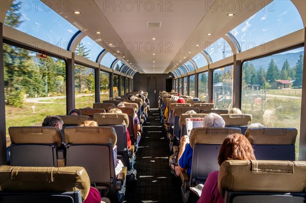 Inside the carriage of the Rocky Mountaineer railway train as it rolls through the countryside of British Columbia, Canada.