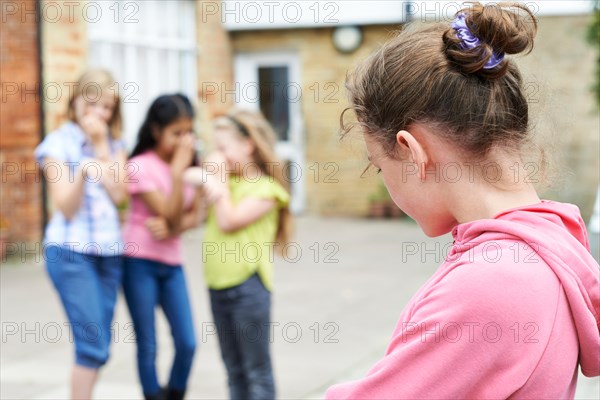 Unhappy Girl Being Gossiped About By School Friends