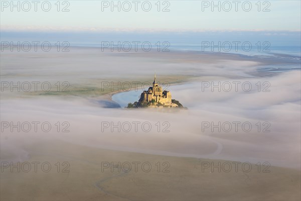 AERIAL VIEW. Abbey on a lofty rocky island in an intertidal zone. Mont Saint-Michel, Manche, Normandie, France.