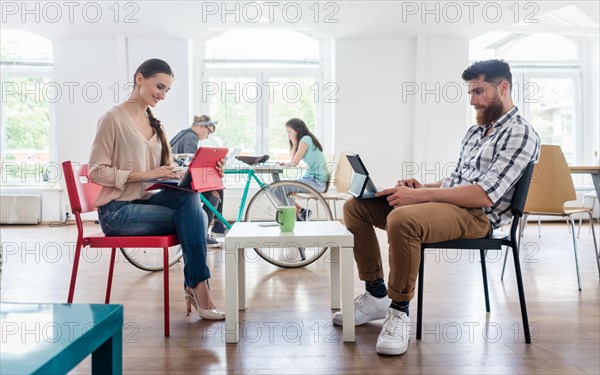 Dedicated young woman editing a document in a modern office spac