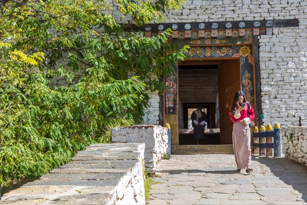 Paro, Bhutan.  Covered Bridge Leading to the Paro Dzong (Fortress).