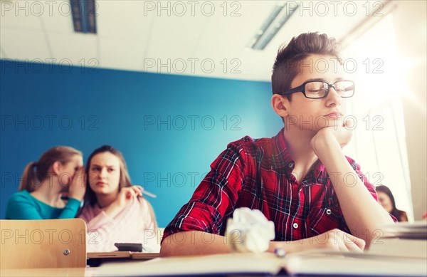 students gossiping behind classmate back at school