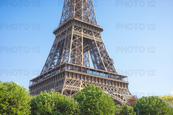 Close up of a part of Eiffel tower against a bright blue sky , Paris , France