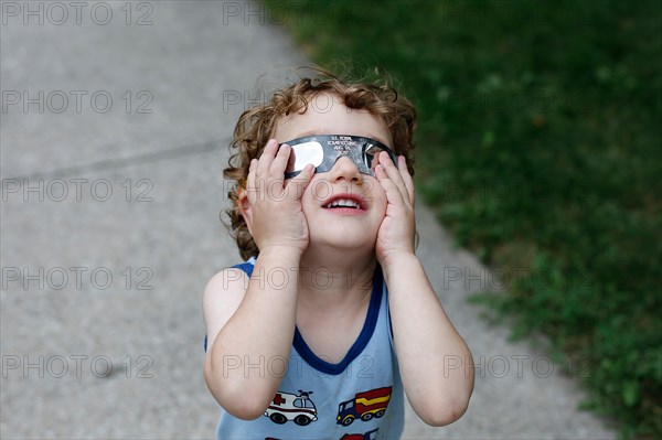 Boy watching solar eclipse