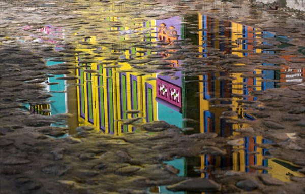 Cobblestone with reflection of colorful City of Guatape, Colombia