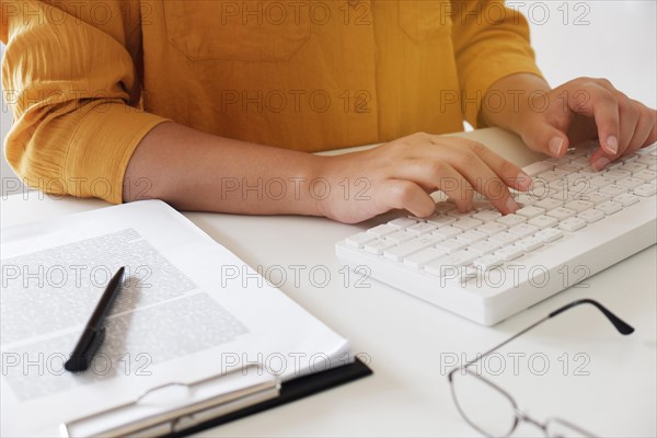 Close-up of female hands. typing in her office