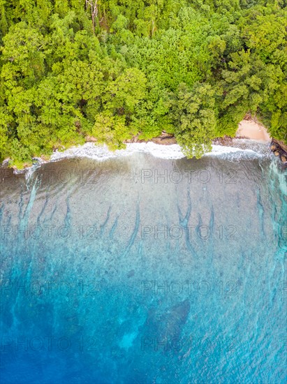 Aerial view of reef and island in Papua New Guinea. The remote, tropical islands in this region are home to extraordinary marine biodiversity.