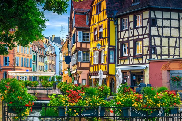 Popular touristic place and travel location. Picturesque street view with colorful buildings and flowers, Colmar, France, Europe