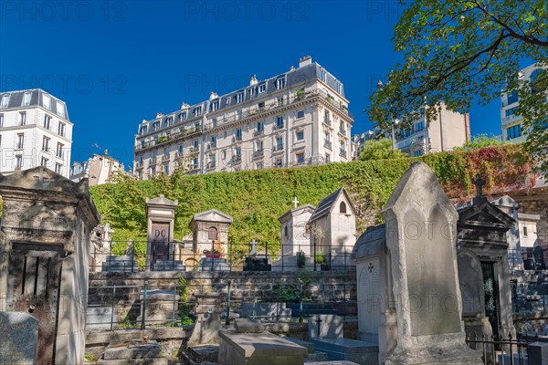 Paris, Montmartre cemetery, graves, with beautiful building in background