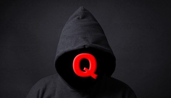 QAnon conspiracy theory - Q symbol on faceless person wearing black hoodie