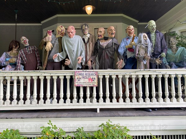 Scary Halloween installation on the porch of a large victorian house in the Flatbush neighborhood of Brooklyn New York.