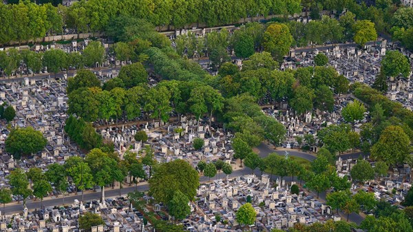 Closeup aerial view of Montparnasse Cemetery (Cimetiere du Montparnasse), second-largest cemetery in Paris, France, with large number of tombstones.