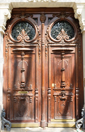 Old ornate door in Paris, France - typical old apartment building.