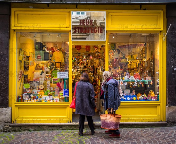 Rouen, France, Oct 2020, two women at the entrance of “Jeux et Strategie” a wooden games and toys store in Saint Nicolas street