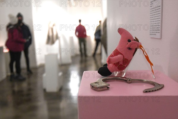 Museum of Broken Relationships: Handcuffs and stuffed pig toy. Zagreb, Croatia