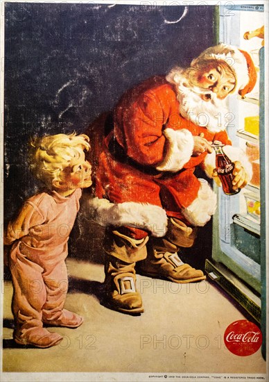 Coca-Cola Christmas. Santa opening a fridge for a child advert in a Natgeo magazine, December 1959