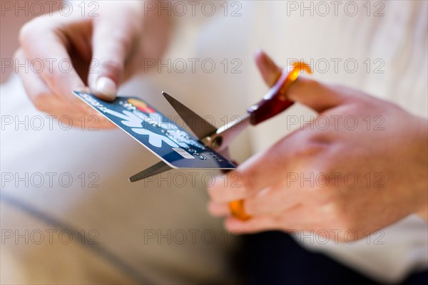 Woman cutting up credit card