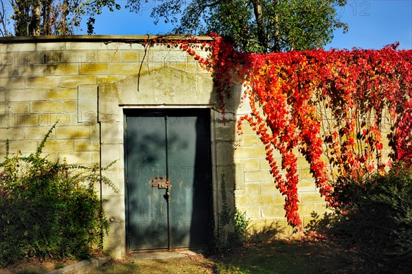 Paris, France - Detail, Pere Lachaise Cemetery, Locked Door on Garden Wall in Autumn