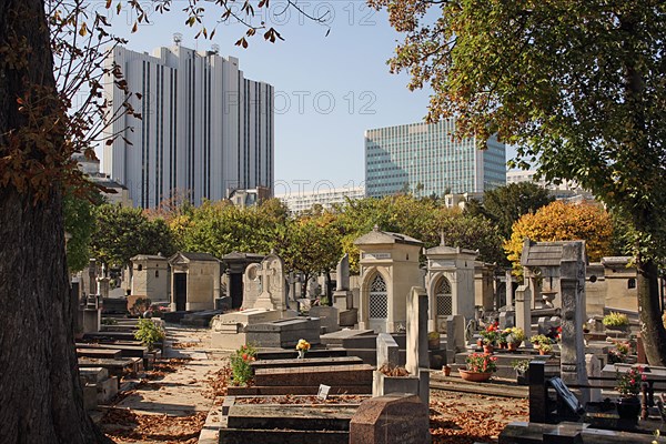 Paris, Cimetiere du Montparnasse with view of commercial skyscrapers