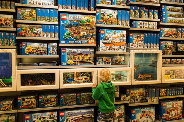 A boy looking at a display in the Lego Store on the shopping street Strøget in Copenhagen, Denmark