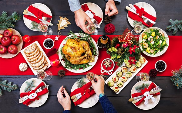 Baked turkey. Christmas dinner. The Christmas table is served with a turkey, decorated with bright tinsel and candles. Fried chicken, table.  Family d