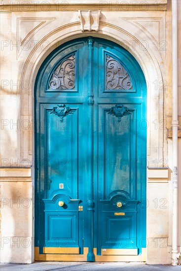 Paris, beautiful wooden door, typical window in the Marais