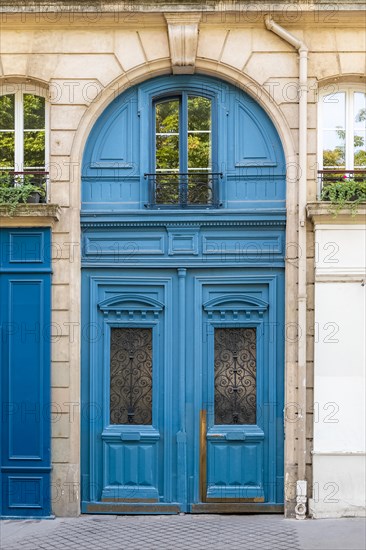 Paris, beautiful wooden door, typical window in the Marais