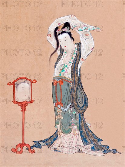 Japan: 'A Chinese Beauty'. Hanging scroll painting by Maruyama Okyo (12 June 1733 - 31 August 1795), 18th century.

Maruyama Okyo, born Maruyama Masataka, was an artist of the Edo Period who specialised in painting in a traditional Chinese style combined with Western elements such as perspective. This features in 'Portrait of a Chinese Beauty' with the use of reflection (albeit inaccurately rendered) in the mirror. He founded the Maruyama school of painting and it proved a success with laypeople, despite the criticism of his fellow artists for his slavish devotion to natural representation.