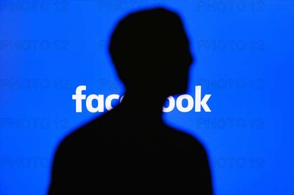 NEW YORK, USA, 25. MAY 2020: Mark Zuckerberg silhouette, Facebook tittle on blue display in background.