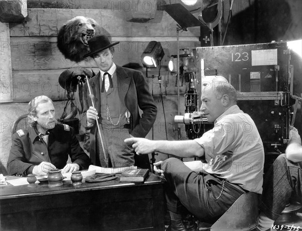 JOHN MILJAN as General George Armstrong Custer GARY COOPER as Wild Bill Hickok and Direcor CECIL B. DeMILLE on set candid during filming of THE PLAINSMAN 1936 director CECIL B. DeMILLE Paramount Pictures