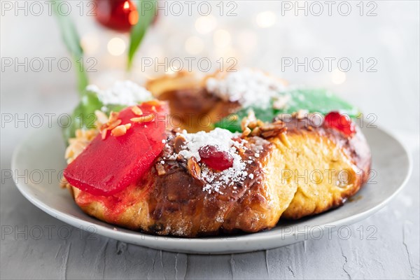 Portuguese Christmas fruit cake Bolo rei on the dish on gray ceramic background