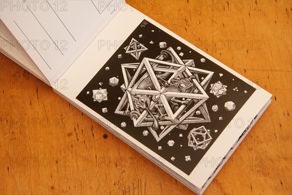 Tear out postcard in a book of MC Escher's mathematical imaginations