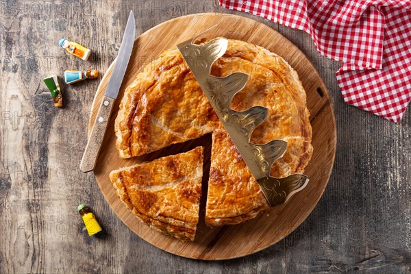 Galette des rois on wooden table. Traditional Epiphany cake in France