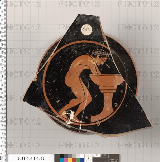 Terracotta fragment of a kylix (drinking cup) 510–500 B.C. Greek, Attic Interior, wreathed youth washing his hands in a laver; part of an inscription, [H]O PAIS [KALOS[. Terracotta fragment of a kylix (drinking cup)  704144