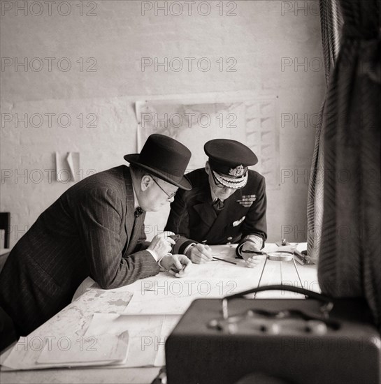 Winston Churchill studies after action reports with Vice Admiral Sir Bertram Ramsay, Flag Officer Comanding Dover, 28 August 1940. Photo by Horton.