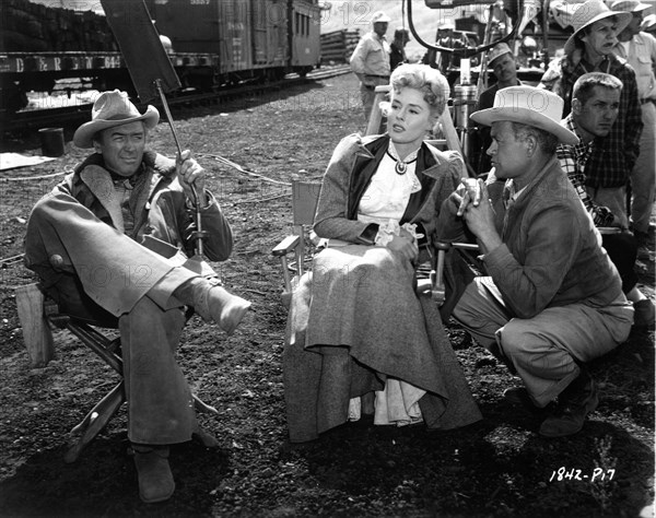 JAMES STEWART ELAINE STEWART and Director JAMES NEILSON with Movie Crew on set location candid in the Colorado Rockies during filming of NIGHT PASSAGE 1957 story Norman A. Fox screenplay Borden Chase music Dimitri Tiomkin cinematographer William H. Daniels costume design Bill Thomas Universal International Pictures