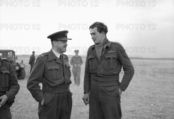 Royal Air Force- 2nd Tactical Air Force, 1943-1945. The Commander-in-Chief of the Allied Expeditionary Air Force, Air Chief Marshal Sir Trafford Leigh-Mallory, chats with Flight-Sergeant T P Fargher at B2/Bazenville, Normandy. Fargher was one of three Supermarine Spitfire pilots forced down in the Caen area after being hit by anti-aircraft fire, to whom Leigh-Mallory offered a lift back to the United Kingdom in his Douglas Dakota, following his visit to General Sir Bernard Montgomery.